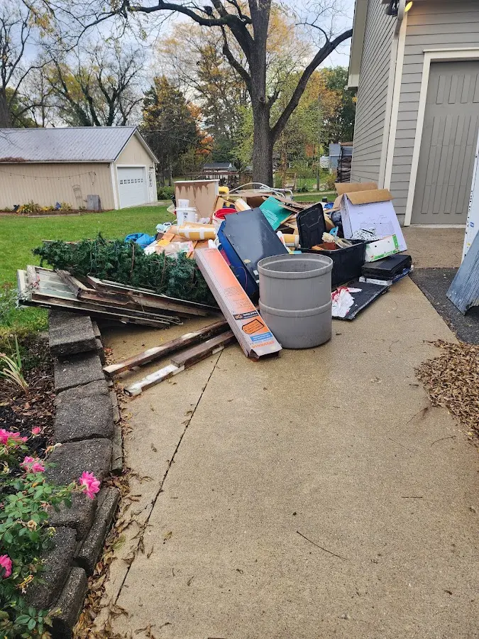 Dumpster being loaded with debris for Roofing Dumpster Rental in White Pigeon